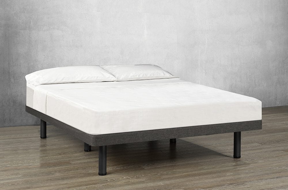 Charcoal gray upholstered platform bed with a white mattress, pillows, and black support legs in a minimal room setting.