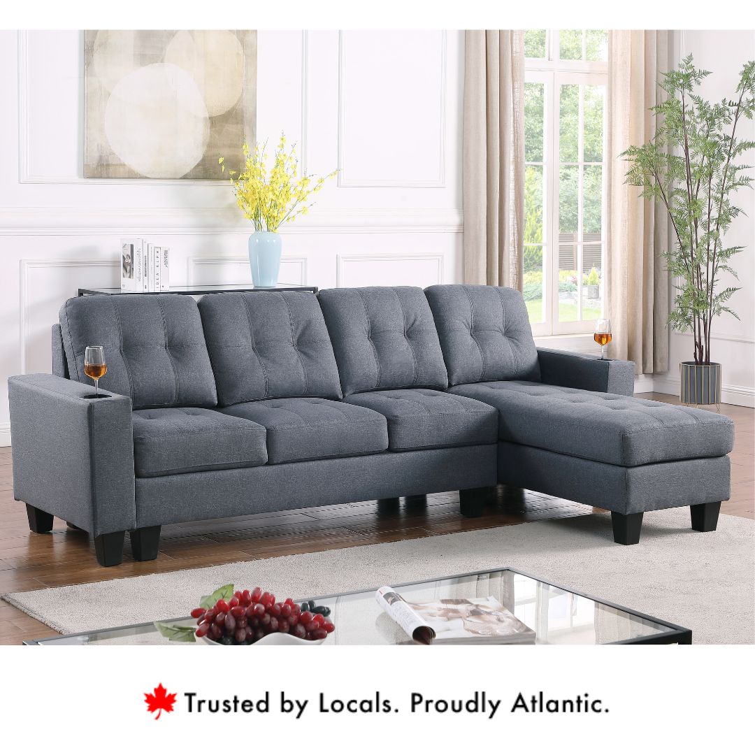 Diamond reversible fabric sectional sofa in grey with tufted cushions and chaise.