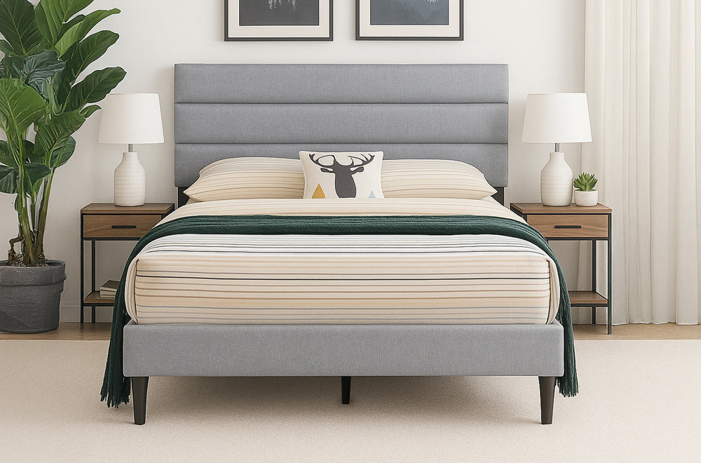 Trawler platform bed in grey linen with horizontal panel headboard, striped beige bedding and green throw