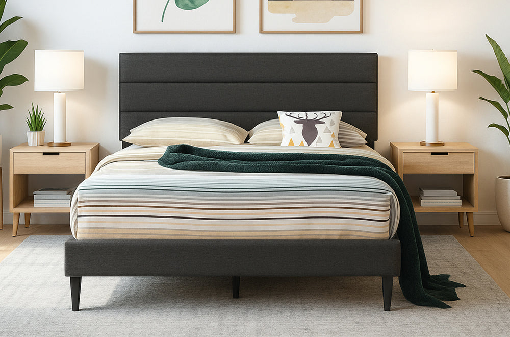 Trawler platform bed in charcoal linen seen straight on with striped bedding, dark green throw, and wooden nightstands