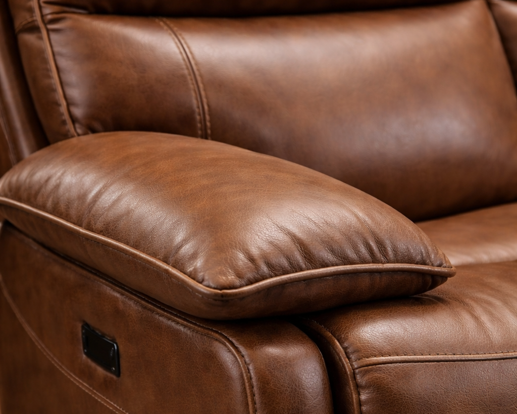 Trafalgar Close-up angled view of caramel leather recliner showing leather grain texture and stitching detail