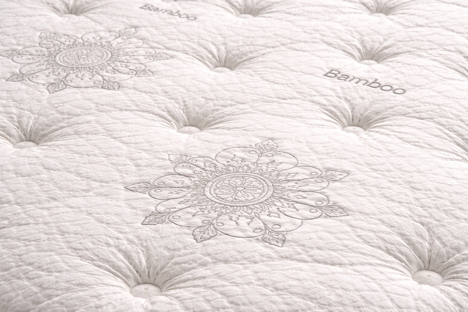 Close-up of Arese Pillow Top mattress showing quilted bamboo fabric, tufted stitching, and detailed pattern texture