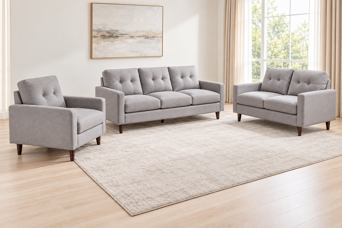 Bella light grey 3-piece sofa set arranged with a matching sofa, loveseat and armchair in a bright room.