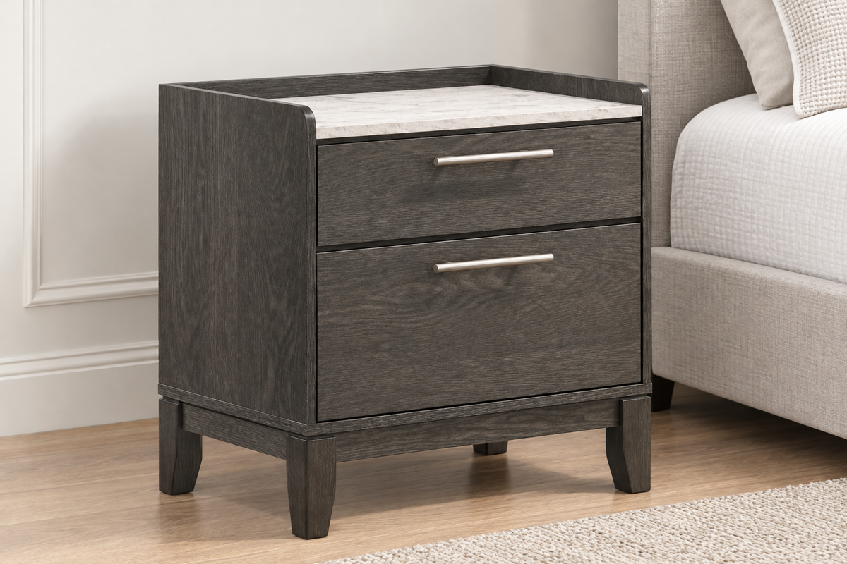 Angled view of the Juliet grey nightstand showing two drawers, metal handles, raised side edges and a light-coloured top.