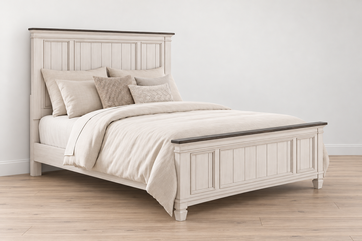 Natasha antique white bed frame with a panel headboard, matching footboard and dark top trim, styled with bedding in a bedroom.
