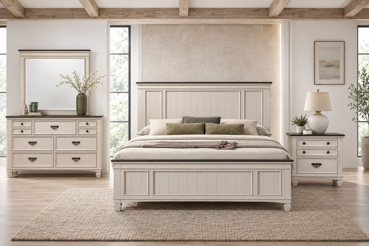 Natasha antique white bedroom set with a bed frame, dresser, mirror and one nightstand, viewed from the front in a bedroom.