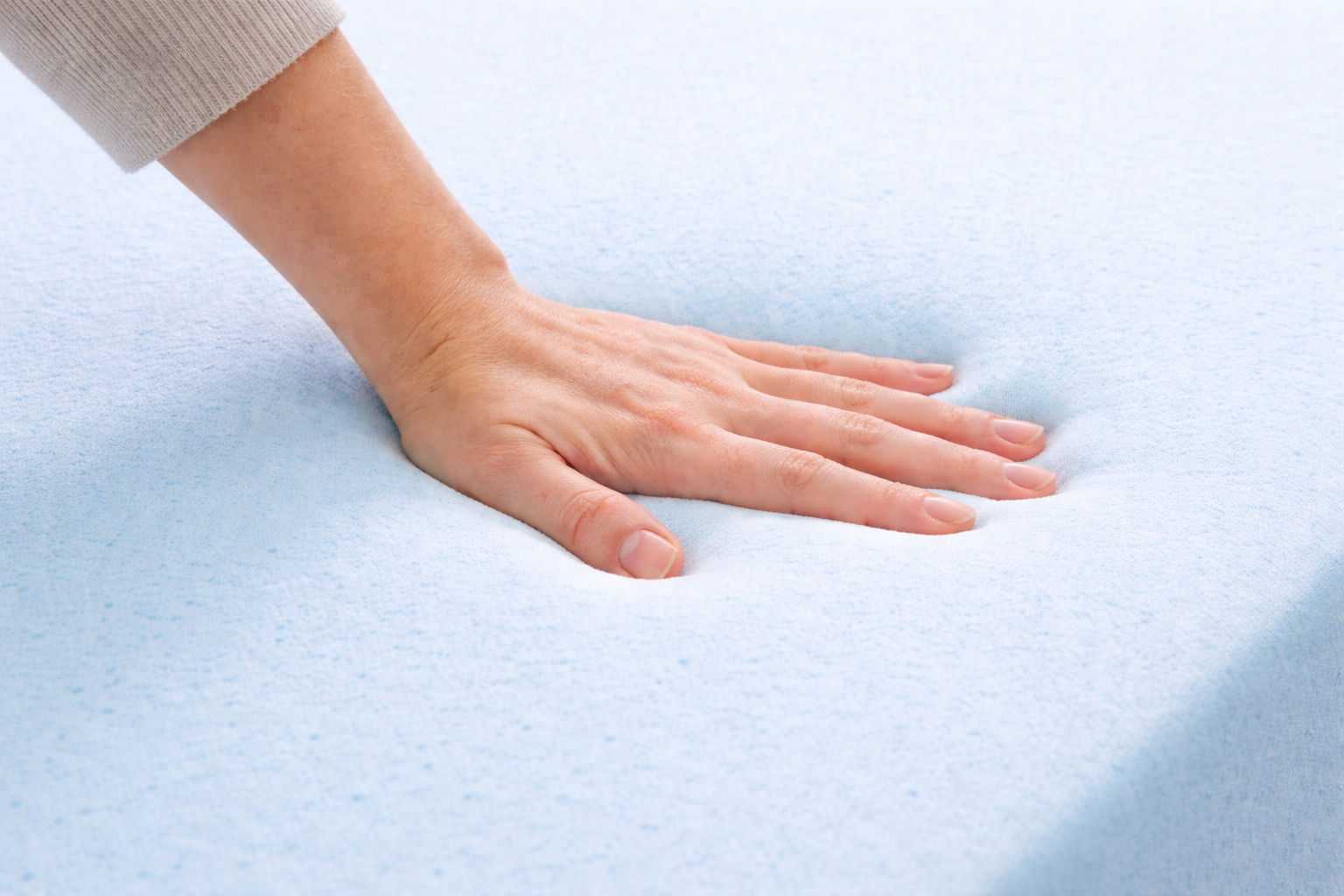 Hand pressing into cooling gel memory foam mattress showing contouring and pressure relief - Furniture Spot Halifax
