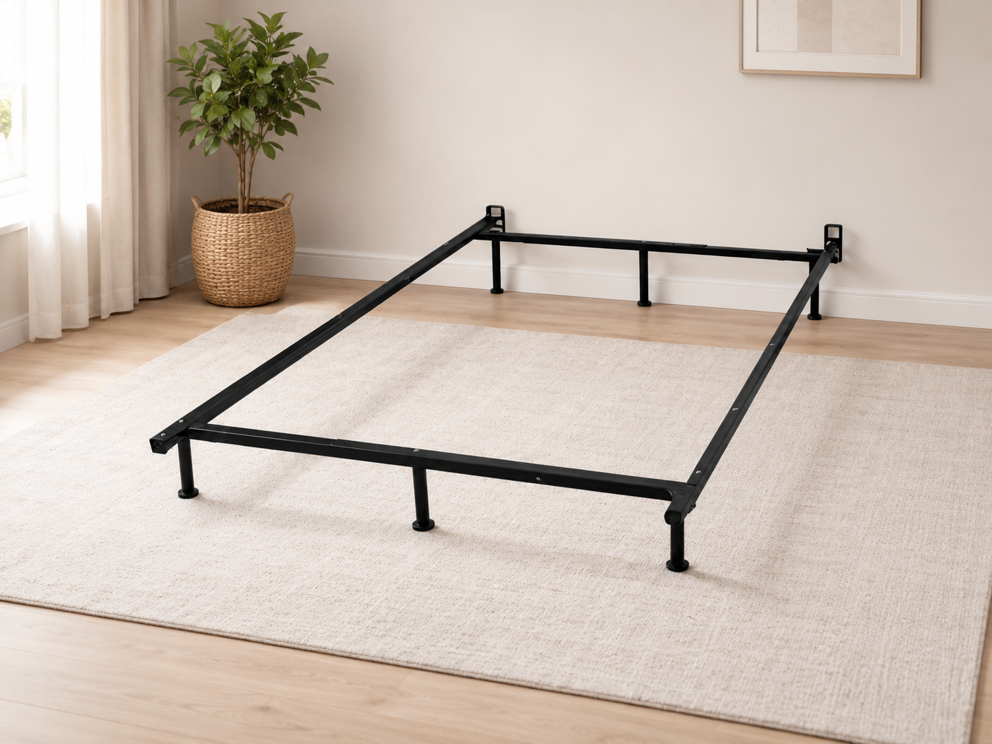 Black metal bed frame foundation with slim rails and support legs in a modern neutral bedroom setting.