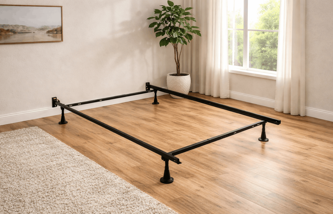 Black metal bed frame foundation with support legs and mounting brackets in a bright neutral bedroom setting.