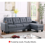 Diamond reversible fabric sectional sofa in grey with tufted cushions and chaise.