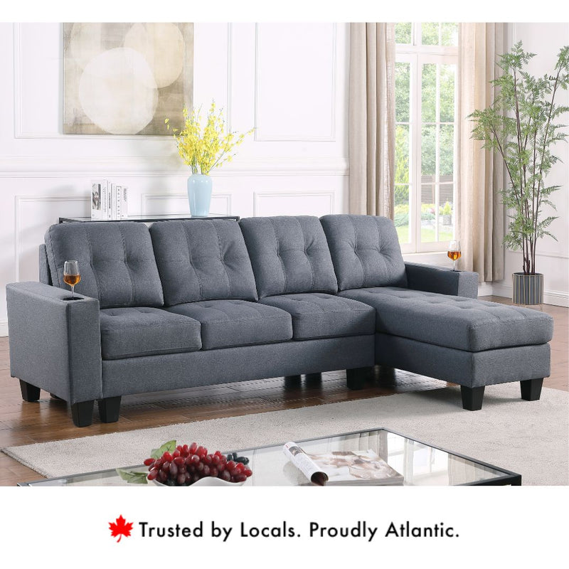 Diamond reversible fabric sectional sofa in grey with tufted cushions and chaise.
