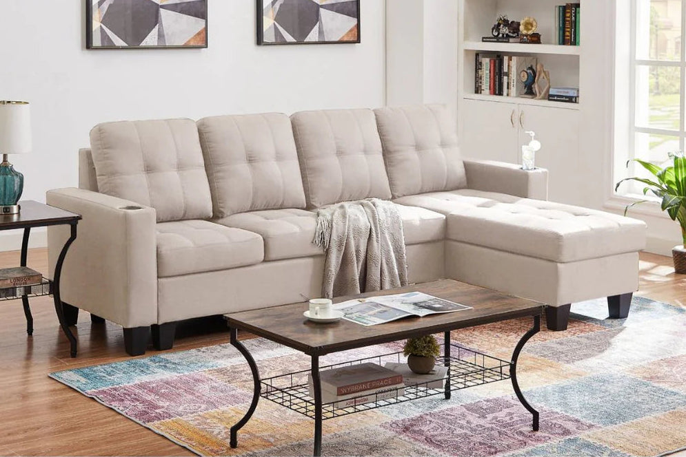 Beige sectional sofa in a living room with a coffee table and decor elements.