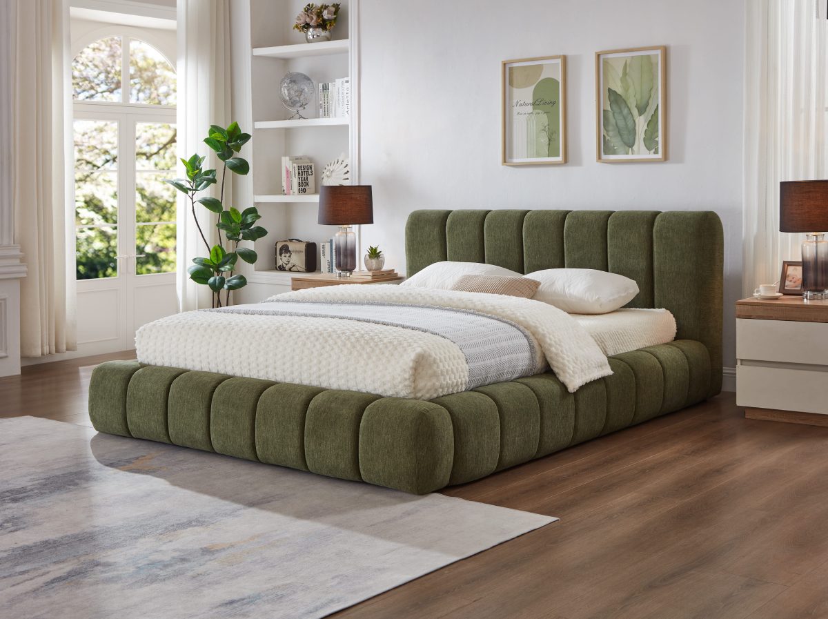 Green Fairview Platform Bed at a three-quarter angle showing vertical channel upholstery beside nightstands and plants