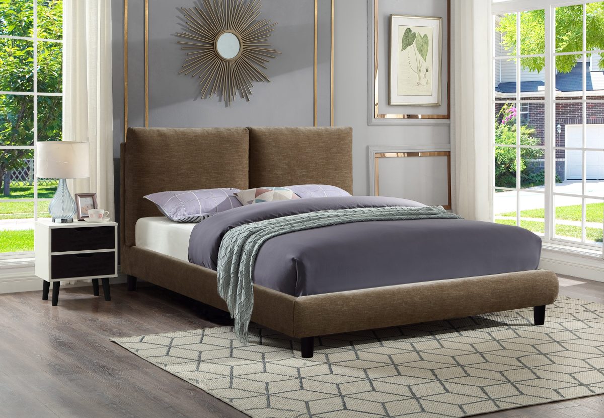 Bronze Cunard platform bed with padded headboard, grey bedding, geometric rug in bright bedroom