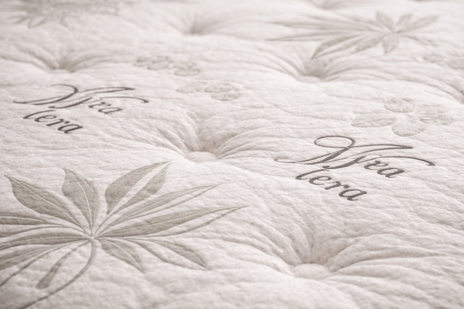 Comfort Best close-up of quilted mattress top showing tufting, stitching, and fabric texture in soft studio lighting.
