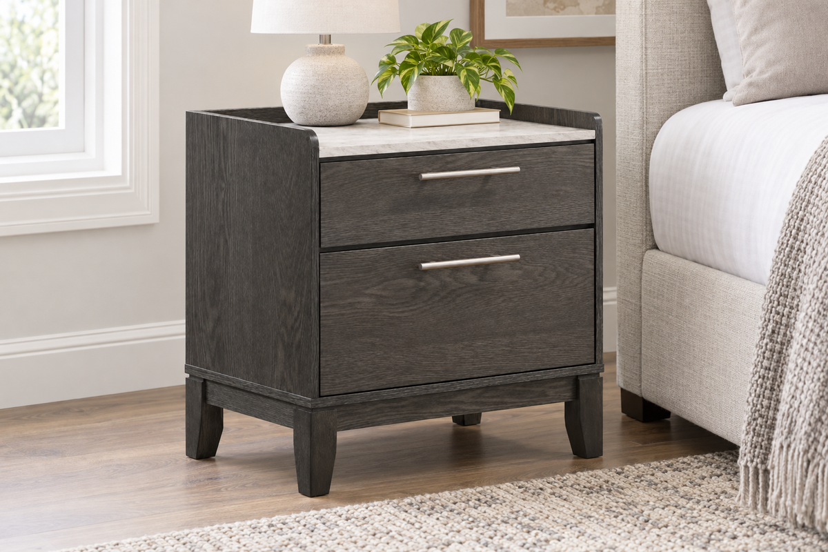 Juliet grey two-drawer nightstand with metal handles and a light-coloured top, styled beside a bed.