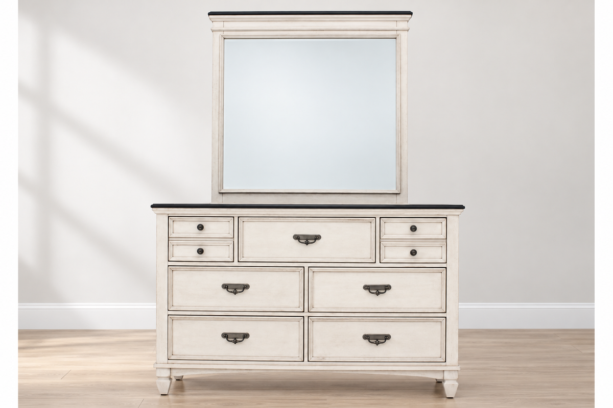 Natasha antique white dresser with a dark top, metal handles and round knobs, styled in a bedroom with the matching mirror, sold separately.