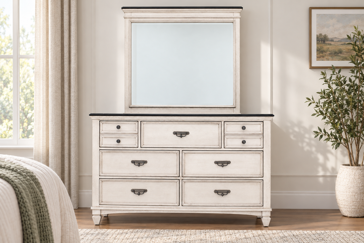 Natasha antique white dresser with a dark top, metal handles and round knobs, styled in a bedroom with the matching mirror, sold separately.