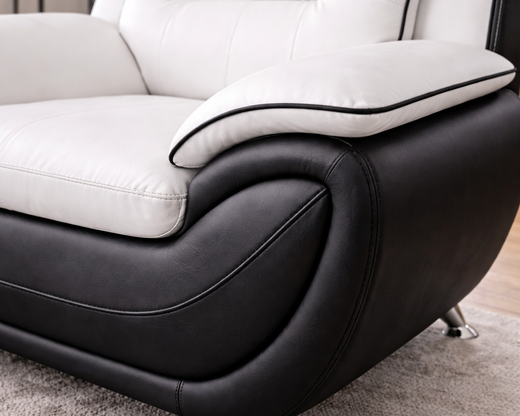 Close-up angled view of white and black leather sofa showing texture and stitching detail